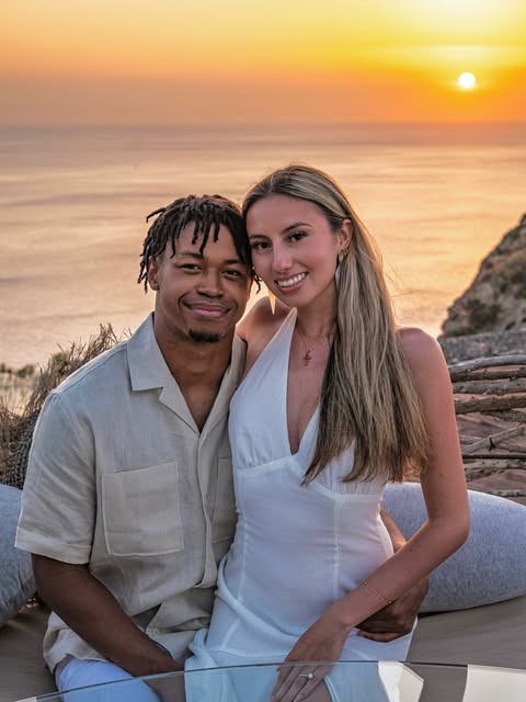 Jenny and her fiancé at sunset by the ocean